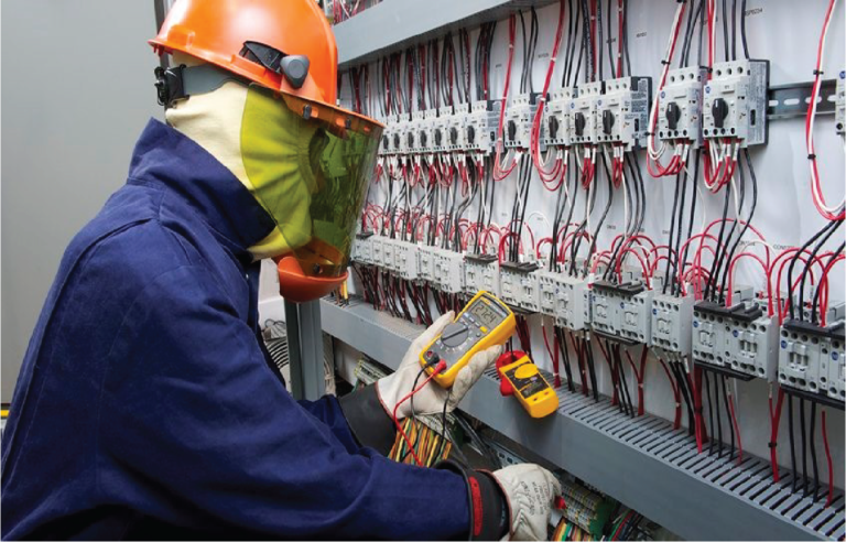 MIJ Technical Services technician testing electrical panel with multimeter for system check